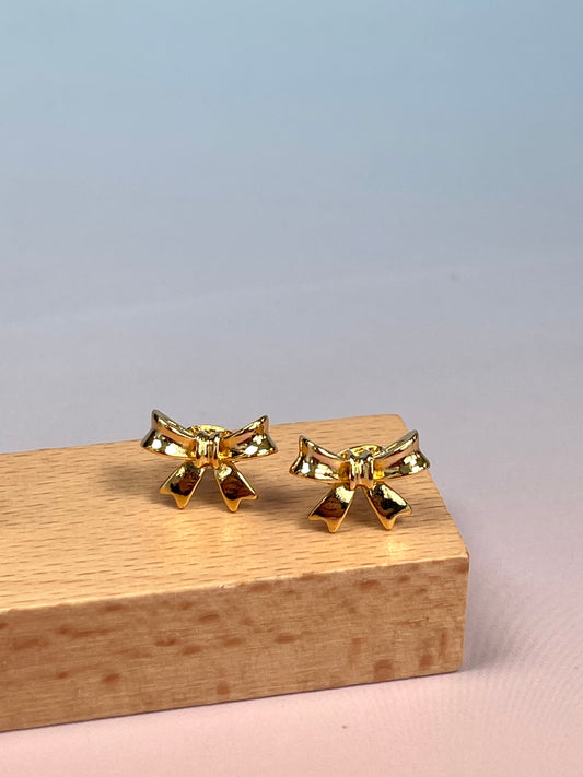 Par de pendientes lazo dorado